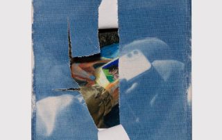 a blue and white torn cyanotype of a person holding what is reveled underneath to be a cellphone